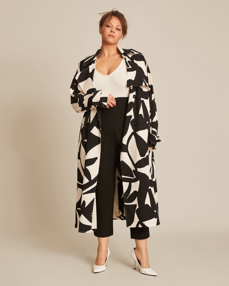 Front of a model wearing a size 12 Demi Trench in Black by 11 Honoré Collection. | dia_product_style_image_id:224127